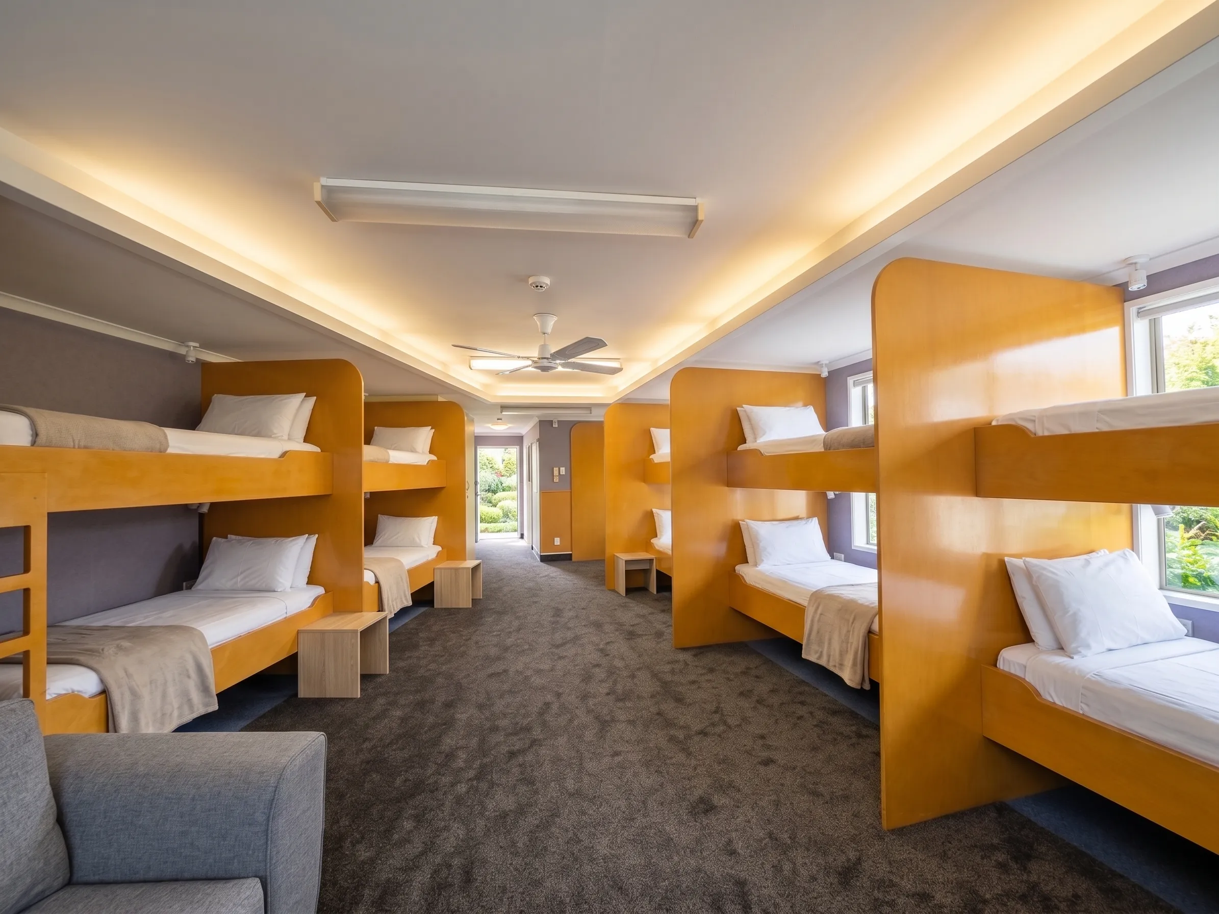 The Lodge group room at Bluewater with twelve single beds and a shared lounge