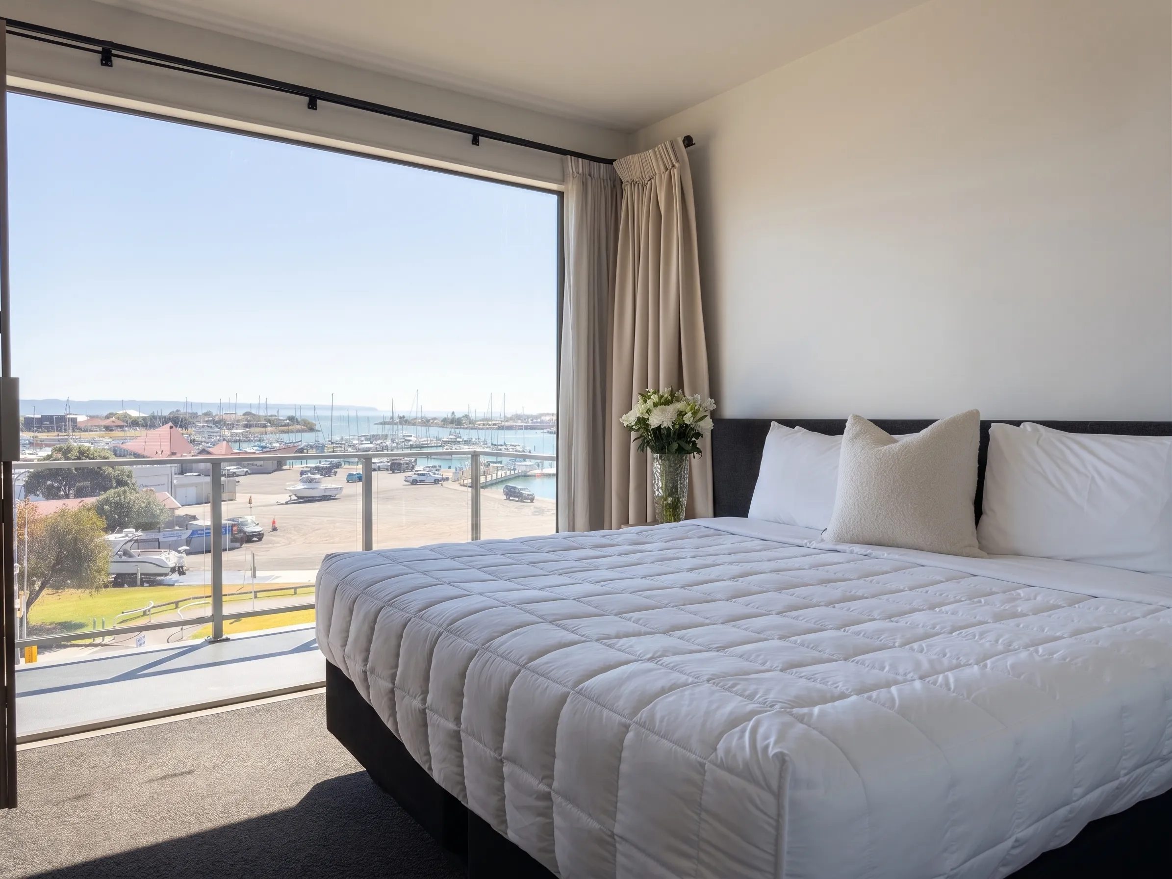 A top-floor Two Bedroom apartment at Bluewater with a private balcony and floor-to-ceiling marina views